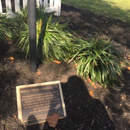 A stone plaque with unreadable engraved lettering