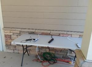 A white rectangle table with phone charging cables.